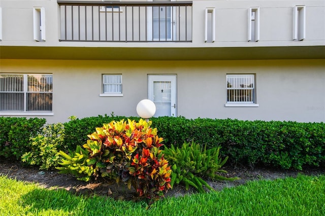 3820 Ironwood Ln Unit 104-I, Bradenton, FL 34209 - view of exterior entry featuring a balcony and stucco siding
