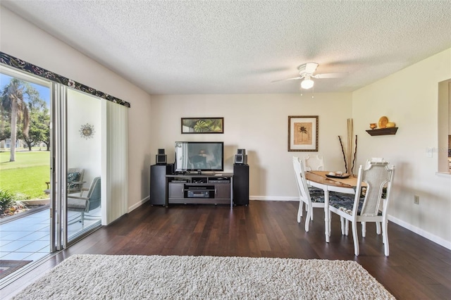 3820 Ironwood Ln Unit 104-I, Bradenton, FL 34209 - dining room with dark wood finished floors, a ceiling fan, baseboards, and a textured ceiling