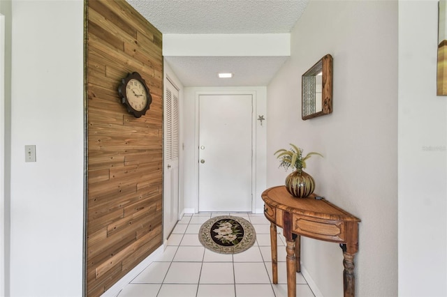3820 Ironwood Ln Unit 104-I, Bradenton, FL 34209 - doorway featuring a textured ceiling, light tile patterned floors, wood walls, and baseboards