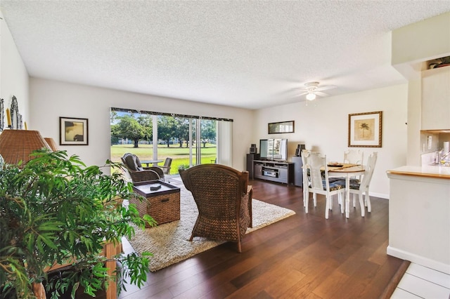 3820 Ironwood Ln Unit 104-I, Bradenton, FL 34209 - living area with dark wood-style flooring, a ceiling fan, and a textured ceiling