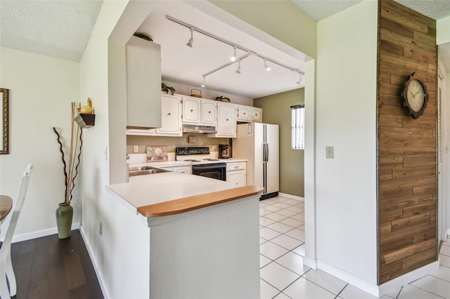 3820 Ironwood Ln Unit 104-I, Bradenton, FL 34209 - kitchen with white appliances, under cabinet range hood, rail lighting, light countertops, and a textured ceiling
