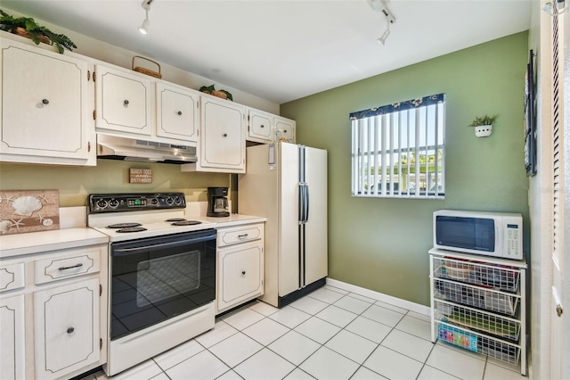 3820 Ironwood Ln Unit 104-I, Bradenton, FL 34209 - kitchen with rail lighting, under cabinet range hood, white appliances, and white cabinetry