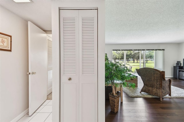 3820 Ironwood Ln Unit 104-I, Bradenton, FL 34209 - hall featuring baseboards, a textured ceiling, and light wood finished floors