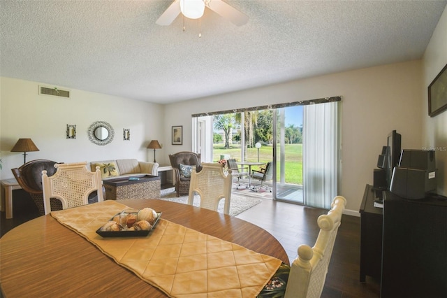 3820 Ironwood Ln Unit 104-I, Bradenton, FL 34209 - dining room featuring wood finished floors, a textured ceiling, a ceiling fan, and baseboards
