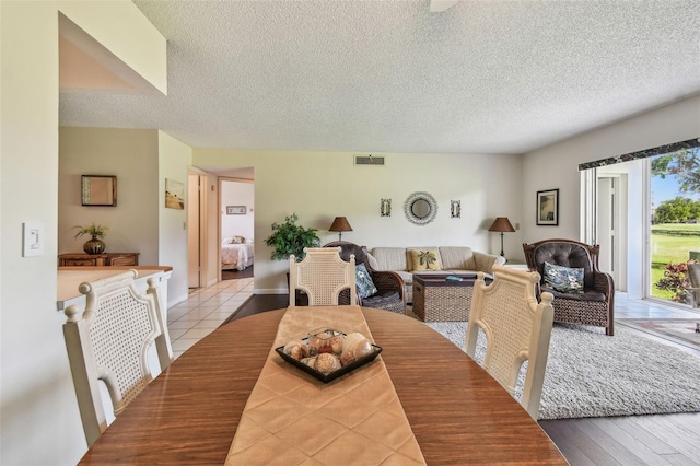 3820 Ironwood Ln Unit 104-I, Bradenton, FL 34209 - tiled dining room with a textured ceiling