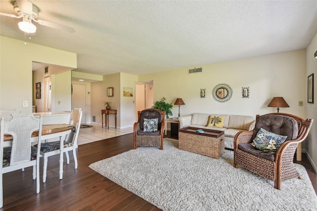 3820 Ironwood Ln Unit 104-I, Bradenton, FL 34209 - living area featuring a textured ceiling, wood finished floors, ceiling fan, and baseboards