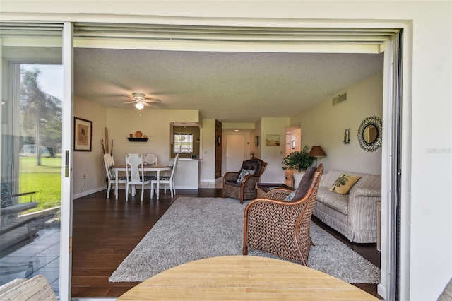 3820 Ironwood Ln Unit 104-I, Bradenton, FL 34209 - living area with a ceiling fan, wood finished floors, and a textured ceiling