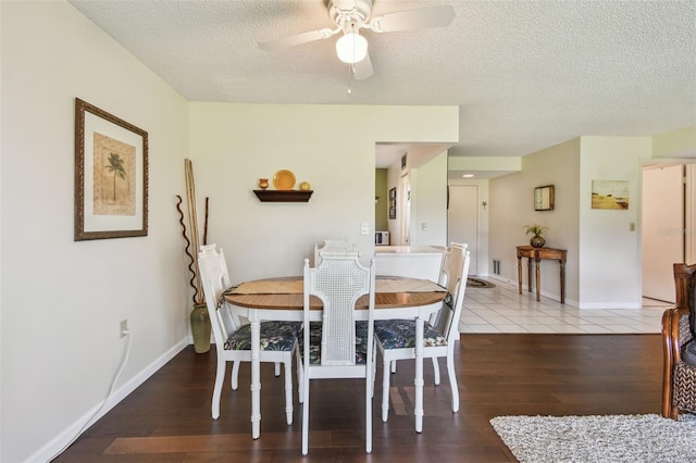 3820 Ironwood Ln Unit 104-I, Bradenton, FL 34209 - dining space featuring a textured ceiling, ceiling fan, wood finished floors, and baseboards