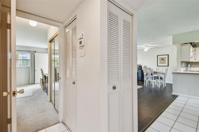 3820 Ironwood Ln Unit 104-I, Bradenton, FL 34209 - hallway featuring a textured ceiling and light tile patterned floors