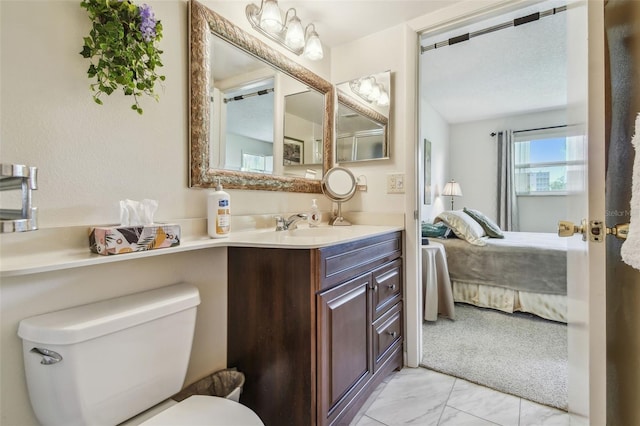 3820 Ironwood Ln Unit 104-I, Bradenton, FL 34209 - ensuite bathroom featuring marble look tiles, toilet, and vanity