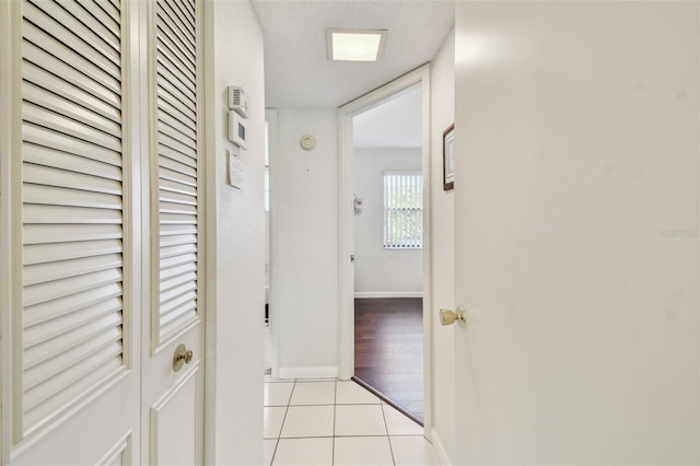 3820 Ironwood Ln Unit 104-I, Bradenton, FL 34209 - hall featuring light tile patterned floors and baseboards