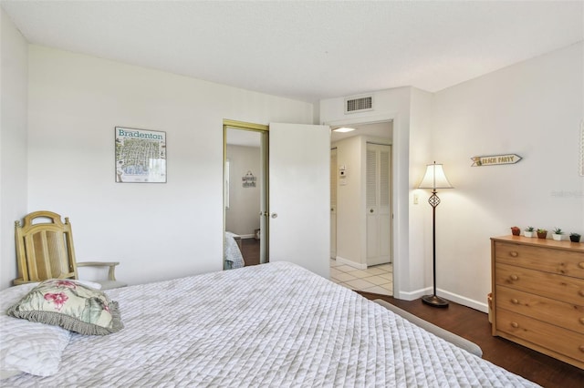 3820 Ironwood Ln Unit 104-I, Bradenton, FL 34209 - bedroom with wood finished floors and baseboards