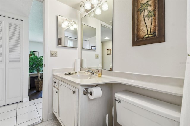 3820 Ironwood Ln Unit 104-I, Bradenton, FL 34209 - half bathroom with toilet, tile patterned floors, vanity, and a closet