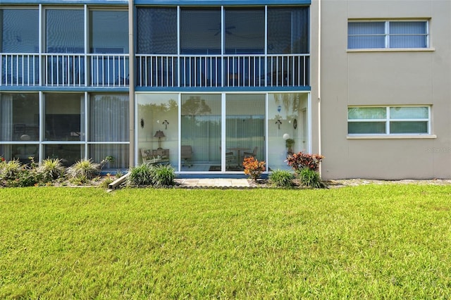 3820 Ironwood Ln Unit 104-I, Bradenton, FL 34209 - rear view of house featuring a lawn and stucco siding
