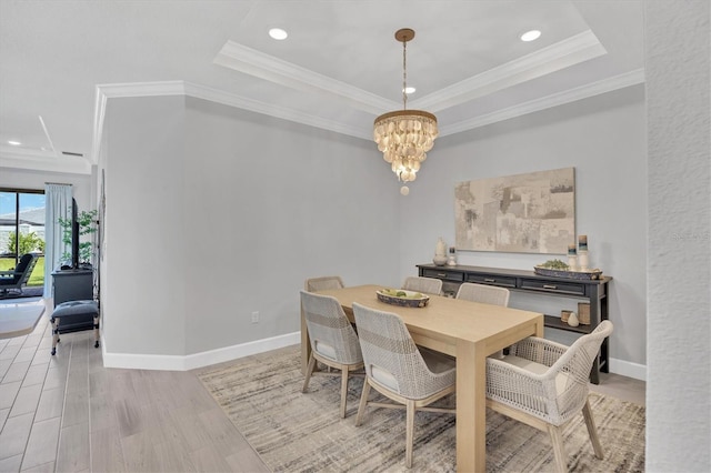 16131 San Donato Pl, Bradenton, FL 34211 - dining space featuring a chandelier, recessed lighting, light wood-style flooring, ornamental molding, and a raised ceiling