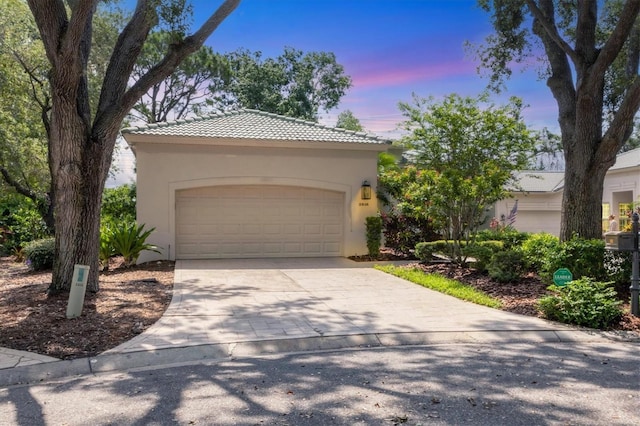 2816 Breton Woods, Sarasota, FL 34235 - view of front facade featuring stucco siding, a tiled roof, concrete driveway, and an attached garage