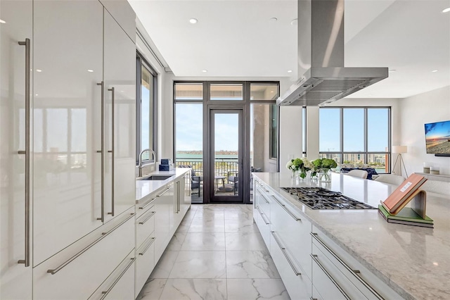 33 S Palm Ave Unit 1101, Sarasota, FL 34236 - kitchen featuring modern cabinets, a sink, island range hood, white cabinets, and light stone counters