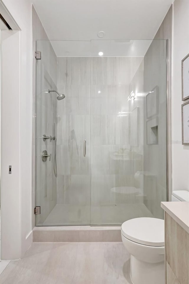 33 S Palm Ave Unit 1101, Sarasota, FL 34236 - bathroom featuring toilet, a shower stall, tile patterned floors, and vanity