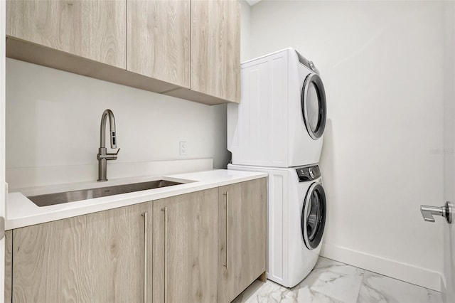 33 S Palm Ave Unit 1101, Sarasota, FL 34236 - laundry room featuring stacked washer / dryer, cabinet space, light marble finish floors, and baseboards