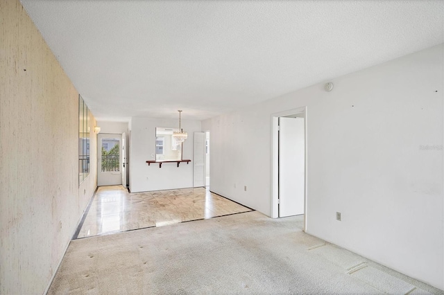 9200 Midnight Pass Rd Unit 30, Sarasota, FL 34242 - spare room featuring light colored carpet and a chandelier
