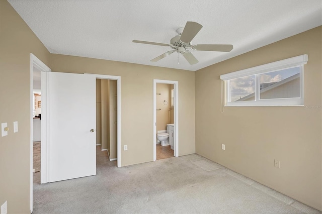 9200 Midnight Pass Rd Unit 30, Sarasota, FL 34242 - unfurnished bedroom with carpet, connected bathroom, a ceiling fan, and a textured ceiling