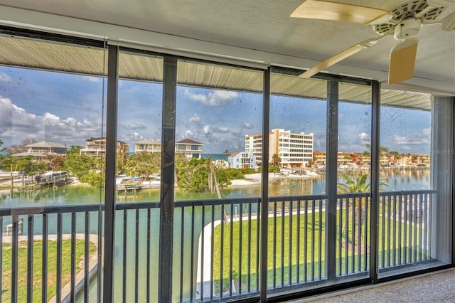 9200 Midnight Pass Rd Unit 30, Sarasota, FL 34242 - unfurnished sunroom with a water view, ceiling fan, and plenty of natural light