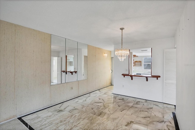 9200 Midnight Pass Rd Unit 30, Sarasota, FL 34242 - spare room with a chandelier and marble finish flooring