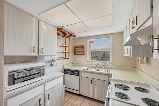 9200 Midnight Pass Rd Unit 30, Sarasota, FL 34242 - kitchen featuring white appliances, a sink, under cabinet range hood, light countertops, and light tile patterned flooring