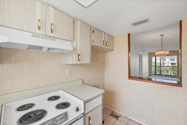9200 Midnight Pass Rd Unit 30, Sarasota, FL 34242 - kitchen with white range with electric cooktop, under cabinet range hood, light countertops, a chandelier, and hanging light fixtures