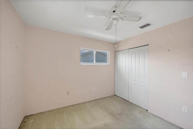 9200 Midnight Pass Rd Unit 30, Sarasota, FL 34242 - unfurnished bedroom featuring light carpet, a closet, and a ceiling fan