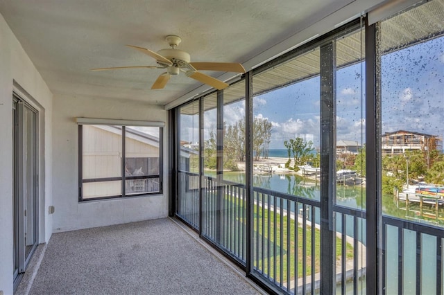 9200 Midnight Pass Rd Unit 30, Sarasota, FL 34242 - unfurnished sunroom with a water view and a ceiling fan