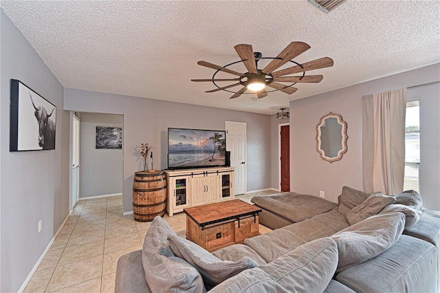 3417 49th St W, Bradenton, FL 34209 - living area featuring a ceiling fan, a textured ceiling, light tile patterned flooring, and baseboards