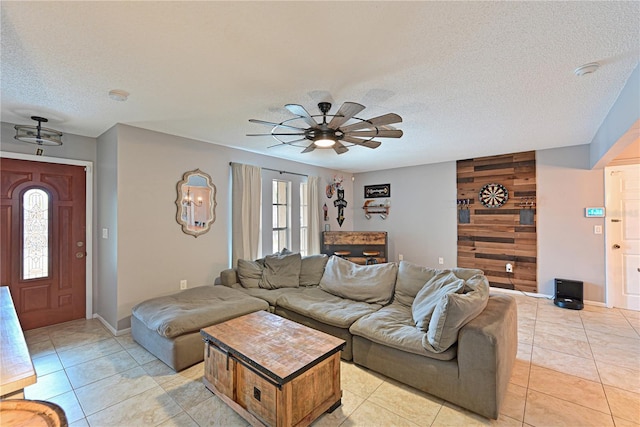 3417 49th St W, Bradenton, FL 34209 - living area featuring a ceiling fan, a textured ceiling, light tile patterned floors, and baseboards