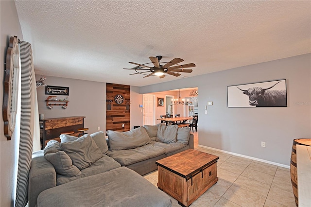 3417 49th St W, Bradenton, FL 34209 - living room with a chandelier, ceiling fan, a textured ceiling, baseboards, and light tile patterned floors