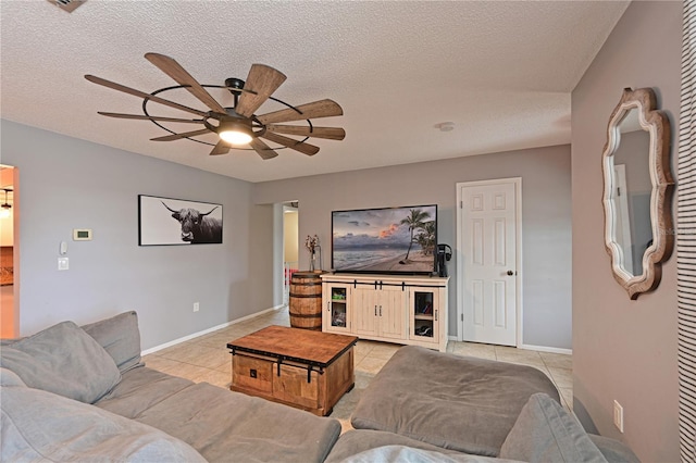 3417 49th St W, Bradenton, FL 34209 - tiled living room featuring a ceiling fan, a textured ceiling, and baseboards