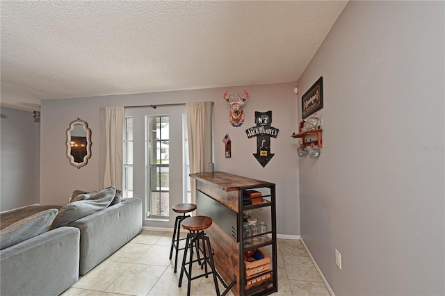 3417 49th St W, Bradenton, FL 34209 - living area with a textured ceiling, light tile patterned floors, and baseboards