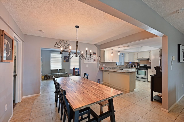 3417 49th St W, Bradenton, FL 34209 - dining area featuring a textured ceiling, a chandelier, light tile patterned floors, and baseboards