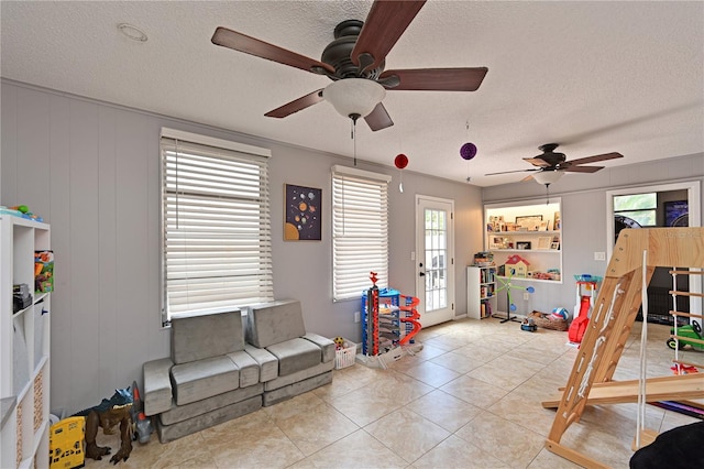 3417 49th St W, Bradenton, FL 34209 - game room featuring a textured ceiling, a ceiling fan, healthy amount of natural light, light tile patterned floors, and french doors