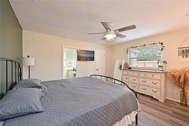 3417 49th St W, Bradenton, FL 34209 - bedroom featuring wood finished floors, a textured ceiling, a ceiling fan, and baseboards