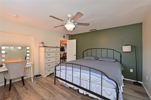 3417 49th St W, Bradenton, FL 34209 - bedroom with wood finished floors, a textured ceiling, a ceiling fan, and baseboards