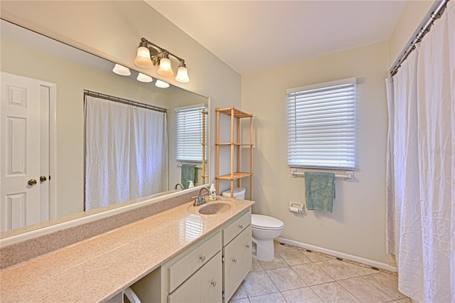 3417 49th St W, Bradenton, FL 34209 - full bath with toilet, vanity, tile patterned floors, baseboards, and healthy amount of natural light