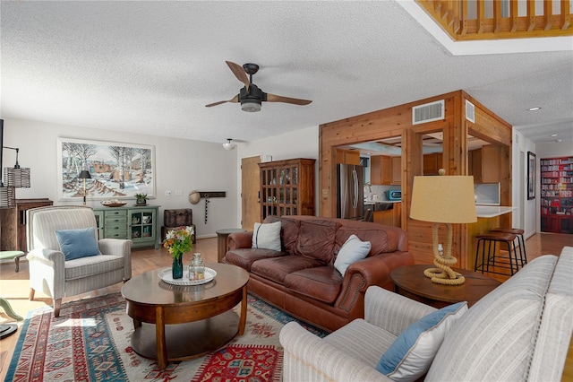 7251 Fish Farm Rd, Palmetto, FL 34221 - living room featuring a ceiling fan, a textured ceiling, and wood finished floors
