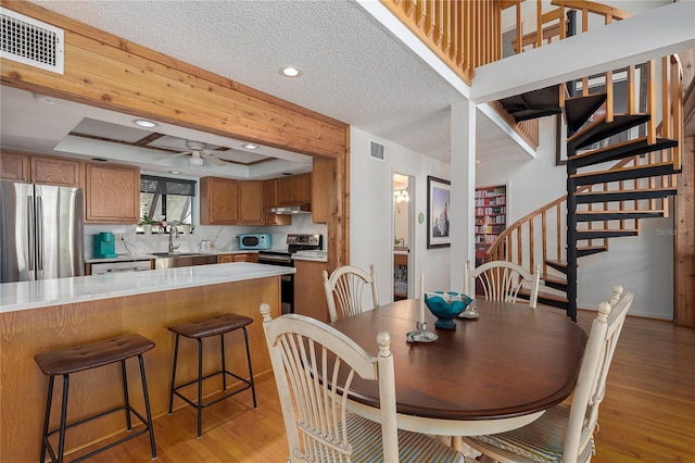 7251 Fish Farm Rd, Palmetto, FL 34221 - dining room with light wood-type flooring, stairs, a ceiling fan, a textured ceiling, and recessed lighting