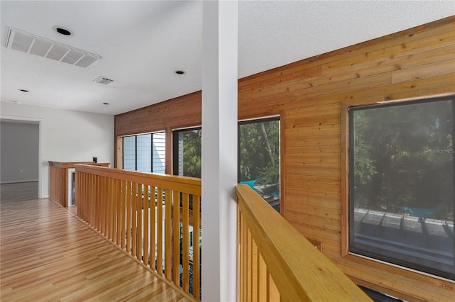 7251 Fish Farm Rd, Palmetto, FL 34221 - corridor featuring wooden walls, plenty of natural light, wood finished floors, an upstairs landing, and recessed lighting