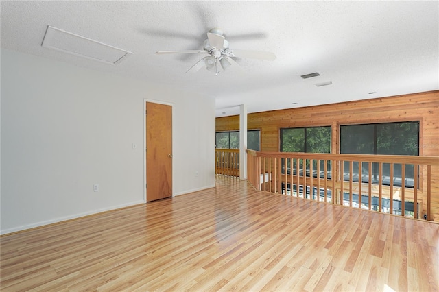 7251 Fish Farm Rd, Palmetto, FL 34221 - unfurnished room featuring a ceiling fan, wood finished floors, wood walls, baseboards, and a textured ceiling