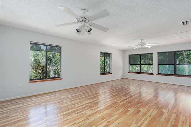 7251 Fish Farm Rd, Palmetto, FL 34221 - unfurnished room featuring healthy amount of natural light, a textured ceiling, light wood-type flooring, and ceiling fan