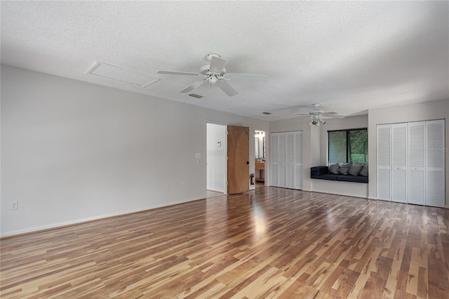 7251 Fish Farm Rd, Palmetto, FL 34221 - unfurnished living room with light wood-style flooring, a ceiling fan, a textured ceiling, and attic access