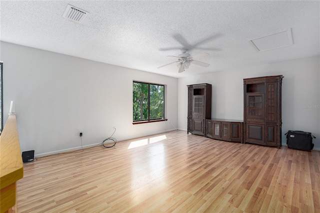 7251 Fish Farm Rd, Palmetto, FL 34221 - unfurnished living room featuring wood finished floors, ceiling fan, a textured ceiling, attic access, and baseboards