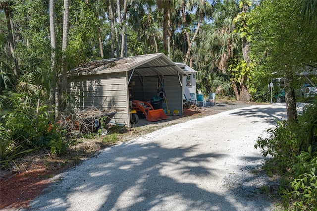7251 Fish Farm Rd, Palmetto, FL 34221 - garage with a detached carport and gravel driveway