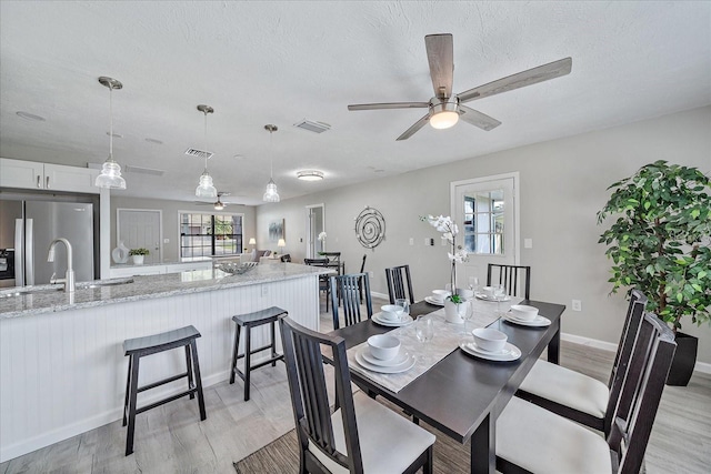 400 E Baffin Dr, Venice, FL 34293 - dining area featuring a ceiling fan and light wood finished floors